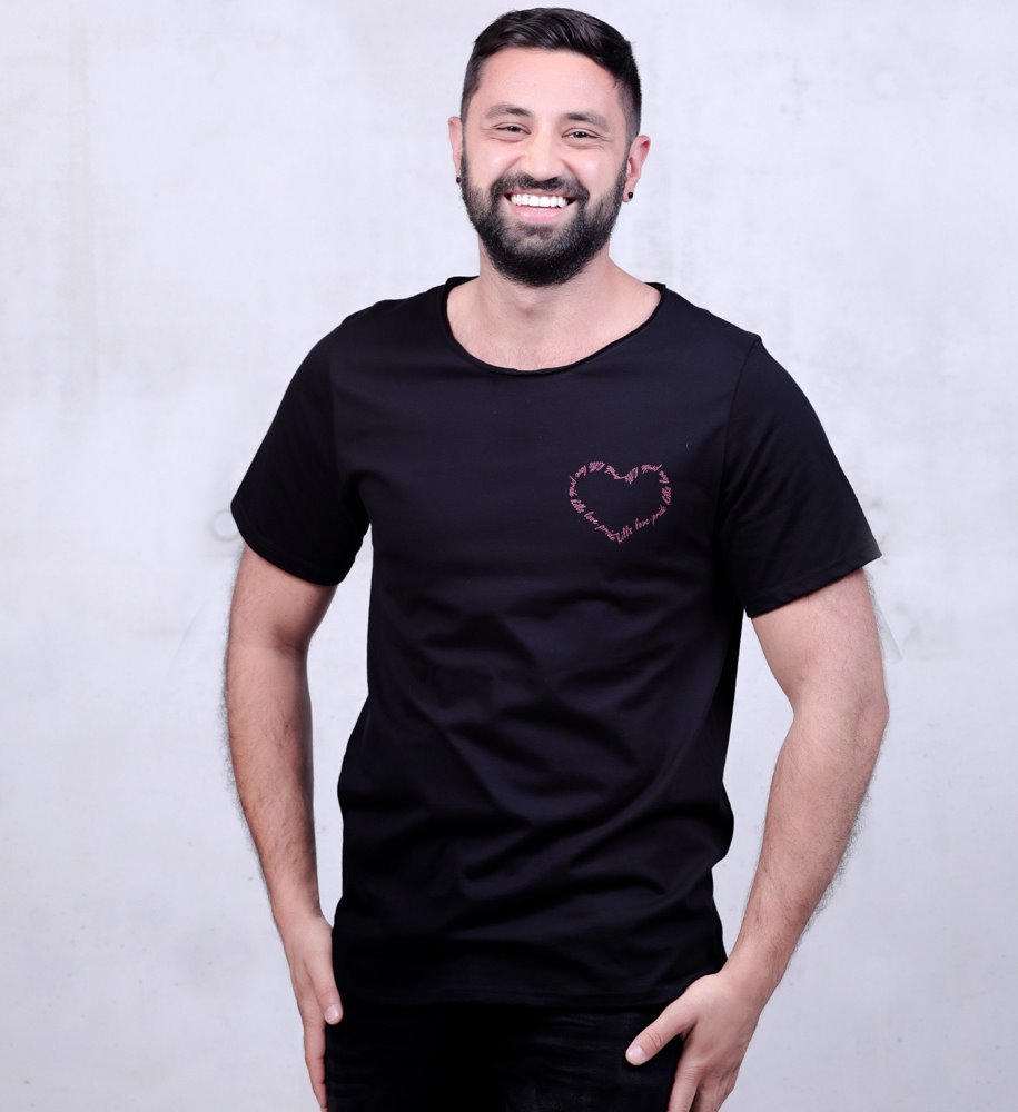 middle eastern guy with cute smile and beard is posing wearing a black pride kills love t-shirt
