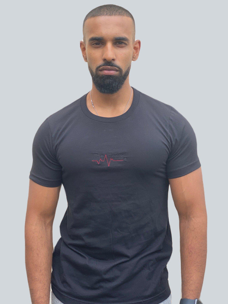 Drake look a like modelling wearing a black tight Supreme Unisex Heartbeat T-shirt showing off his muscles