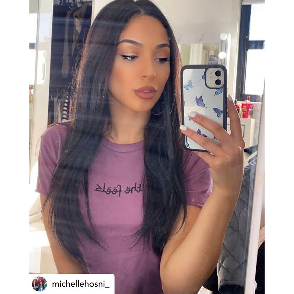 Instagram famous Michelle Hosni taking a selfie wearing the Plum Arabic Script Crop in her room